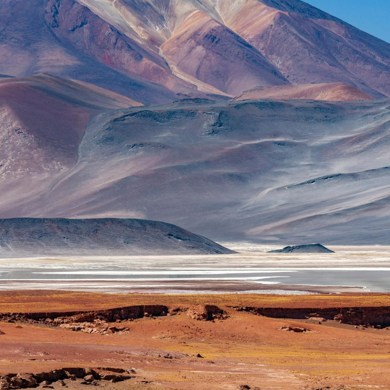 Challenges to InvestmentIn the early 2000s, Chile’s development of non-conventional renewable energy (NCRE) sources – solar, geothermal, biomass, wind, small-scale hydro, and biomass/biogas –&nbsp;was limited, representing a low share of electricity production despite significant natural potential. At that time, large-scale NCRE investment projects faced challenges, particularly high costs and market concentration among a relatively small number of large players. The country lacked a comprehensive incentive structure to help drive down NCRE investment costs. The existing transmission infrastructure was also insufficient to integrate NCRE sources, which are often location-specific (e.g. hydro power must be located near bodies of water). Chile required significant policy interventions to address these challenges and to lower entry barriers for small and new players in the NCRE space.Approach&nbsp;In 2010, Law No. 20.257 came into force in Chile, introducing a quota obligating an explicit amount of electricity generation from NCRE sources. Per the new law, electricity companies generating more than 200 MW were mandated to supply 5% of their marketed energy from NCRE sources over the period 2010-2014. This quota would increase further by an annual rate of 0.5 percentage points after 2015, with a view to reach 10% of supply by 2024. According to the law, NCRE sources were defined as solar, wind, bioenergy, biomass, geothermal, mini-hydro, and tidal. Electricity companies who failed to comply with the law would be subject to a tax for each MWh of deficit versus the quota obligation. Any electricity company exceeding its NCRE obligation could transfer its surplus to another electricity company. On 14 October 2013, Law No. 20.698 increased the quota goal from 10% by 2024 to 20% by 2025. If the overall NCRE deployment target wasn’t met, the Ministry of Energy would be required to offer public tenders to allocate the remaining NCRE capacity.&nbsp;&nbsp;Key Enabling Conditions&nbsp;The Ministry of Energy emphasized the development of NCRE as a key aspect of the National Energy Strategy 2012-2030 for Chile. This commitment demonstrated the credibility and long-term intention of the government and instilled confidence in investors. The establishment of the Ministry of Energy in 2010 further reflected Chile’s dedication to promote NCRE, and created a clear penalty system when the quota was not met. Additionally, investors and stakeholders’ awareness of the geographic potential for renewable energy sources in Chile supported the development and utilization of NCRE.&nbsp;Impact / OutcomesChile’s quota policy helped to open the market for NCRE, mandating NCRE installation, fostering greater competition and sending price signals that incentivized investment into NCRE technologies. Although the policy also included penalties where the quota was not met, NCRE generation has consistently exceeded the annual quota target, expanding rapidly after the law’s implementation. In 2017, seven years after the law’s implementation, NCRE capacity exceeded the quota of 3,642 GWh by more than three times, reaching 11,087 GWh. By 2020, NCRE accounted for 23.4% of total generation, surpassing the 20% target set for 2025 five years ahead of schedule.&nbsp;Additional SourcesIRENA (2015), Renewable Energy Policy Brief: Chile; IRENA, Abu Dhabi, https://www.irena.org/-/media/Files/IRENA/Agency/Publication/2015/IRENA_RE_Latin_America_Policies/IRENA_RE_Latin_America_Policies_2015_Country_Chile.pdf?la=en&amp;hash=304E17839F669D9E62CD40C68391A31364F97892 Ministry of Energy / GIZ Chile (2018), Non-Conventional Renewable Energies in the Chilean Electricity Market, https://www.acera.cl/wp-content/uploads/2019/08/2018-Las-ERNC-en-el-Sistema-Ele%CC%81ctrico-Chileno-ingle%CC%81s.pdf Ministry of Energy (2012), Estrategia Nacional de Energía 2012-2030, https://cdn.climatepolicyradar.org/navigator/CHL/2008/national-energy-strategy-2012-2030_60b1e85645ccbe3ef86808c37b11780a.pdf Nasirov S, Silva C, Agostini CA. Investors’ Perspectives on Barriers to the Deployment of Renewable Energy Sources in Chile. Energies. 2015; 8(5):3794-3814. https://doi.org/10.3390/en8053794 Renewable Energy Center (2012), Chile: Development &amp; opportunities of the Solar Energy Market https://www.rifs-potsdam.de/sites/default/files/files/13-repla_potsdam_-2012-10-02-chile.pdf Serra, P. (2022). Chile's electricity markets: Four decades on from their original design. Energy Strategy Reviews, 39, 100798, https://www.sciencedirect.com/science/article/pii/S2211467X21001814 https://bcn.cl/2epdk https://www.bizlatinhub.com/chile-renewable-energy-paradise/ https://climateactiontracker.org/countries/chile/policies-action/ https://climate-laws.org/document/law-no-20-257-on-non-conventional-renewable-energies_0bc5 https://climatepolicydatabase.org/policies/law-no-20257-non-conventional-renewable-energies-chile-2008 https://www.iea.org/policies/4853-non-conventional-renewable-energy-law-law-20257 https://jia.sipa.columbia.edu/news/renewable-energy-chile-barriers-and-role-public-policy 