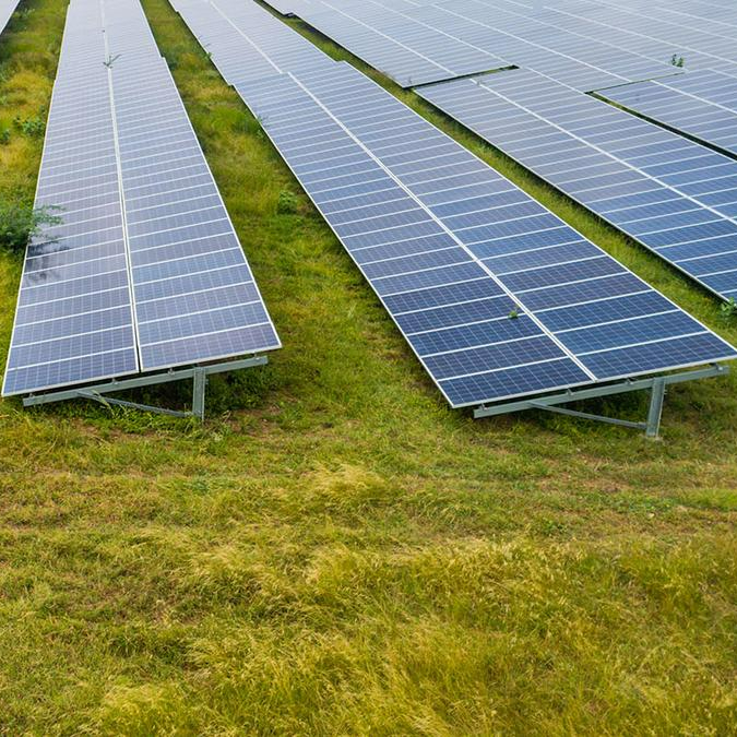 Challenges to investmentIndia’s energy demand has surged since economic liberalization in the early 1990s. In 2015, India released its Nationally Determined Contribution under the Paris Agreement (updated in 2023), committing to reduce emissions intensity of its HDB by 45% and source 50% of power generation from non-fossil fuel sources by 2030. To meet this goal, India needed to promote private investment in renewable energy (RE). However, potential clean energy producers faced challenges enforcing contracts with their partners, given the lack of a comprehensive national framework to promote private RE investment, inadequate coordination among key institutions governing RE, volatile solar and wind tariffs, high credit risk in Power Purchase Agreements (PPAs), and the lack of standardized contracts.&nbsp;&nbsp;&nbsp;ApproachIn the 2000s’s, the government of India (GoI) took progressive steps to improve contract enforcement, particularly in the electricity sector. The Electricity Act of 2003 was a key legislative framework which consolidated laws and policies for electricity generation, transmission, distribution, and trading. The Act introduced the Central Electricity Regulatory Commission (CERC) and State Electricity Regulatory Commissions (SERCs) as regulatory bodies. The CERC oversees inter-state electricity transmission and generation and formulated the National Electricity Policy in 2005, and the Tariff Policy in 2006. Meanwhile, the SERC determines state-level electricity tariffs and ensures compliance. The Act facilitates RE contracts through Section 86(1)(e) on generation and co-generation from renewable sources, Section 62 on determining tariffs for electricity services, and Section 42 on open access for electricity distribution. The Act also defines PPAs as contracts between a power buyer and a power producer at an agreed tariff, tenor and capacity. If the definition is not limited to renewable energy, it creates a clear transactional framework including both Utility PPAs, signed between RE producers and state-owned or private utilities, and corporate PPAs, signed between RE producers and private corporations.&nbsp;&nbsp;Key Enabling ConditionsThe GoI’s commitment to RE contract enforcement was complemented by financial and regulatory support for RE contracts. These include Accelerated Depreciation (AD) for tax benefits for solar projects, Generation-Based Incentives (GBI) for wind energy, and Viability Gap Funding (VGF) for solar projects, ensuring fixed tariffs and funding up to 30% of project costs. The Insolvency and Bankruptcy Code (IBC), released in 2015, consolidated insolvency laws in India, and governs all companies, including government utilities. State-level mechanisms include Renewable Purchase Obligations (RPOs), which mandate bulk buyers to source a percentage of power from RE sources, driving demand for PPAs. Non-compliance requires purchase of Renewable Energy Certificates (RECs), traded nationally to meet RPOs.&nbsp;Impact / OutcomesA robust policy framework for enforcement of RE contracts increased investor confidence and helped advance clean energy investment, with the share of modern renewables in final energy consumption rising 50% from 2000 to 2020. As of February 2024, India ranked fourth globally in renewable installed capacity, with RE comprising approximately 43% of the power capacity mix in fiscal year (FY) 2023-24. In 2019 for example, corporate renewable PPAs added 1.4GW of capacity. For example, Idea purchased 6,576 MWh of solar power PPAs in FY 2018, saving 5,392 tons of CO2 emissions. Godrej, sourcing over 51% of its energy through renewables, reduced its GHG emissions by 42% since 2011, with its Godrej Tyson Food plant procuring 100% of its power through solar and wind PPAs.Additional SourcesNational Institution for Transforming India. (2024). Renewable Energy Resource Adequacy Planning to meet RPO by the States in India. https://www.niti.gov.in/sites/default/files/2024-02/Policy%20Paper_Energy_12022024_V4.pdfWorld Business Council for Sustainable Development. (2023). Corporate Renewable PPAs in India, https://www.wbcsd.org/wp-content/uploads/2023/12/WBCSD_PPA_India.pdfCentral Electricity Regulatory Commission. (2003). The Electricity Act, 2003 with amendments. https://www.cercind.gov.in/Act-with-amendment.pdfhttps://www.reuters.com/world/india/india-spend-up-385-bln-meet-renewable-energy-target-moodys-ratings-estimates-2024-06-06/https://www.mondaq.com/india/renewables/1254524/the-continued-rise-of-renewable-corporate-ppas-in-indiahttps://ijpiel.com/wp-content/uploads/2022/10/Regulators-and-Regulation-under-the-Electricity-Act-2003.pdfhttps://www.wbcsd.org/resources/accelerating-corporate-procurement-of-renewable-energy-in-india/https://cercind.gov.in/Function.htmlNational Electricity Policy | Government of India | Ministry of Power (powermin.gov.in)https://www.iea.org/countries/indiahttps://pib.gov.in/PressReleaseIframePage.aspx?PRID=1987752