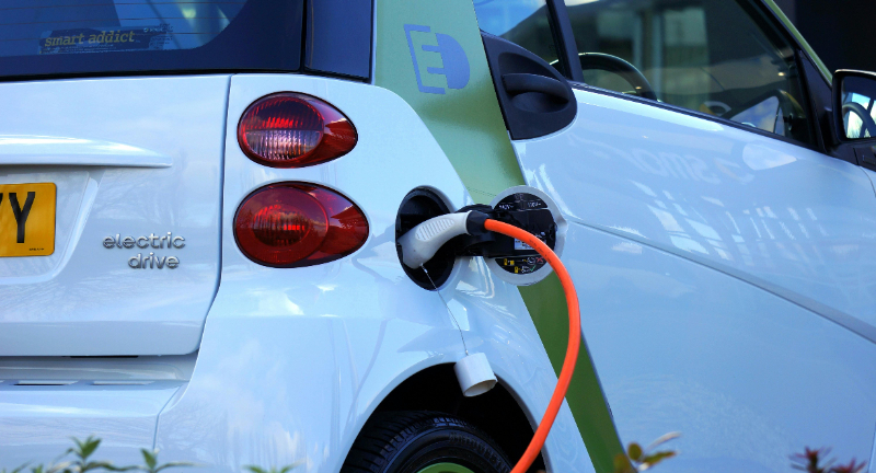 Combining smart electric-vehicle (EV) charging with microgrids – integrating rooftop solar, on-site battery storage and intelligent load control – offers a scalable strategy for buildings, campuses and mixed-use developments to manage rising electricity demand while decarbonizing. As EV adoption accelerates, unmanaged charging risks overloading building grid connections and triggering costly upgrades. Smart charging systems apply dynamic load management, adjusting charging rates in real-time based on building load, feeder constraints, renewable output and tariff signals. This helps avoid overloads, improve phase balancing and shift demand to lower-cost periods.&nbsp;Microgrids enhance these capabilities by supplying and storing local renewable energy and shaving peak demand through coordinated dispatch of PV, storage and flexible loads. During upstream grid disturbances, microgrids with islanding capability can maintain EV-charging operations for priority vehicles or services, improving operational resilience. Together, smart charging and microgrids increase self-consumption of on-site solar, reduce coincident peaks, protect transformer and feeder capacity and enable more predictable, cost-effective charging behavior as electrification expands.&nbsp;Main outcomes of the solution Affordability: Reduces operational costs by shifting EV charging into lower-tariff periods and decreasing peak-demand charges. Microgrids with on-site solar and storage further reduce electricity expenses and may defer grid-connection upgrades.&nbsp;Reliability &amp; Flexibility: Improves load stability by coordinating EV charging with building demand, renewable output and storage capacity. This supports consistent charging availability and reduces the likelihood of overloads on internal or upstream grid infrastructure.&nbsp;Business value: Creates structured investment opportunities through measurable cost reductions, avoided infrastructure upgrades and the potential for standardization across building portfolios. Reliable EV-charging services support utilization and long-term asset performance.&nbsp;Key deployment and scaling factors Smart charging systems capable of scheduling and modulating charging in response to building load and grid signals.&nbsp;On-site renewable generation and battery-energy storage sized to expected EV demand and facility load.&nbsp;Integrated controls that coordinate charging, storage dispatch and building energy management.&nbsp;Clear economic modelling of demand-charge mitigation, self-consumption benefits and potential export revenue.&nbsp;Regulatory frameworks that allow flexibility services, time-of-use optimization and microgrid interconnection.&nbsp;Case Study Scale Microgrids (2025), USA Scale Microgrids is constructing a renewable energy microgrid to support a zero-emission electric bus fleet at the Santa Clara Valley Transportation Authority (VTA)’s Cerone Bus Depot in San Jose, California. The project integrates on-site solar generation, battery energy storage and smart EV charging infrastructure to support fleet operations while managing local electricity demand.&nbsp;&nbsp;The system under construction includes approximately 500 kW of solar PV canopies, around 4 MWh of battery storage and up to 3 MW of fleet-charging capacity. Bus charging is planned primarily overnight, aligning energy use with lower electricity tariffs and available on-site generation to ensure vehicle availability for morning service.&nbsp;&nbsp;The microgrid is designed to enhance operational resilience by supporting charging and essential depot functions during periods of grid stress or outages, with the option to connect temporary backup generation if required. The facility will remain grid-connected, with Pacific Gas &amp; Electric upgrading local utility infrastructure and adding 3 MW of capacity to support growing electricity demand.&nbsp;VTA has indicated that the infrastructure is expected to underpin the deployment of 35 battery-electric buses planned for 2026 and support its longer-term transition toward a 100% zero-emission bus fleet, in line with California state requirements.[1]References: Electrifying Public Transit: Scale Microgrids Building Renewable Energy Microgrid for Santa Clara Valley Transit Authority I Microgrid Knowledge (October 2025)