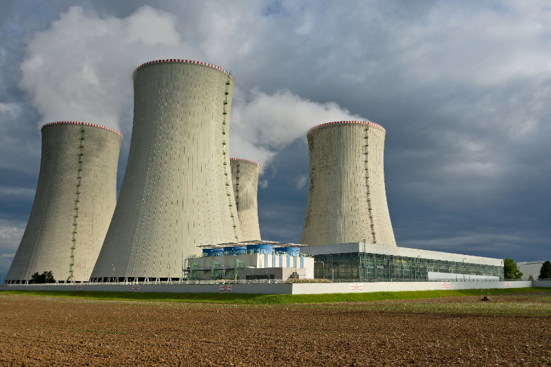 A nuclear-powered data center combines stable nuclear electricity, high-efficiency computing infrastructure, and recovered thermal energy to support artificial intelligence workloads with lower carbon intensity and higher power reliability. The model connects a data center to nearby nuclear generation so that servers can run on continuous low-emissions power rather than relying only on grid electricity exposed to fossil fuel mix, congestion, or renewable intermittency. It also uses surplus heat or steam from nuclear operations to drive absorption cooling, district cooling, or other thermal systems that reduce the electricity normally consumed by conventional chillers. This matters because artificial intelligence training, cloud computing, and large-scale data storage require dense, uninterrupted power and significant cooling capacity. By pairing nuclear power with intelligent energy management, waste-heat utilization, advanced cooling, and digital operations control, the solution can lower power usage effectiveness, reduce grid stress, improve uptime, and create a scalable pathway for clean, resilient digital infrastructure in regions with existing or planned nuclear assets.Main outcomes of the solutionReliability &amp; Flexibility: The solution gives power systems a stable anchor load supplied by dispatchable, low-emissions nuclear generation. This reduces exposure to intermittent supply, grid congestion, and power quality fluctuations while supporting the continuous electricity profile required by artificial intelligence computing. System Resilience: By locating high-demand computing capacity close to firm generation and using integrated cooling systems, the solution reduces dependence on long-distance grid delivery and backup diesel generation. It strengthens continuity for critical digital infrastructure while easing pressure on transmission and distribution networks. Sustainability: The solution cuts power system emissions by shifting data center demand toward low-emissions electricity and reducing cooling-related electricity consumption through recovered heat or steam. It improves resource efficiency by turning surplus thermal energy into a useful input for data center temperature control.Key deployment and scaling factorsSite the data center close to nuclear generation with sufficient grid interconnection capacity and land-use approvals to reduce transmission constraints and improve supply continuity. Design cooling systems around recovered heat, steam-driven cooling, liquid cooling, or hybrid approaches from the start rather than retrofitting conventional electric chillers after construction. Align nuclear safety, cybersecurity, data protection, emergency planning, and critical infrastructure rules before scaling operations. Use long-term power and heat offtake contracts between the nuclear operator, data center owner, cloud customers, and grid operator to reduce investment risk. Phase new computing capacity with available power, cooling capacity, and local grid reinforcement to avoid creating new system bottlenecks.Case studyQinshan Nuclear Power Plant Co, China National Nuclear Research Institute and China National Nuclear Corporation (2023), ChinaThe Qinshan Nuclear Industry Data Center in Haiyan County, Zhejiang Province, was developed by China National Nuclear Corporation and Qinshan Nuclear Power as a nuclear-powered digital infrastructure platform for China’s nuclear sector. Located inside the Qinshan nuclear power base, the project links high-reliability computing demand with one of China’s established nuclear generation sites, using the operating characteristics of nuclear power - stable output, high availability, and low operational carbon emissions - to support cloud services, artificial intelligence, big data, and nuclear production management systems. The facility was built to national Class A data center standards and planned as a secure, centralized platform for sector-wide digital operations.Public project information states that the center occupies 15,000 square meters of land and follows a one-off planning and phased commissioning model. Its first phase brought four information technology module rooms and 506 standard cabinets into operation, with rapid expansion capacity for 300 additional cabinets and long-term reserved space for 1,200 more. The project demonstrates how nuclear operators can extend the value of nuclear assets beyond electricity generation by using firm clean power to host energy-intensive intelligent computing close to the source. Project-reported outcomes indicate annual clean electricity consumption of more than 175 million kilowatt-hours, annual carbon emissions reduction of 10,675 tonnes, and annual power cost savings of more than USD 3 million. The case shows how nuclear power can underpin resilient, low-carbon data center operations while supporting digital modernization across safety-critical industrial systems.References:The Path to a New Era for Nuclear Energy – Analysis - IEAEnergy supply for AI – Energy and AI – Analysis - IEAExecutive summary – Nuclear Power and Secure Energy Transitions – Analysis - IEAInformation provided to World Economic Forum by Qinshan Nuclear Power Plant Co (May 2026)